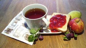 Blushing Plum-Jam Enjoyed on Toast with Tea and Fruit